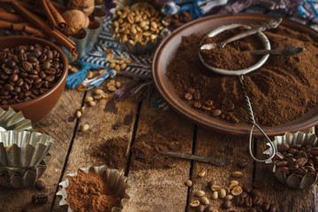 Roasted black and green coffee beans and ground coffee in the plate