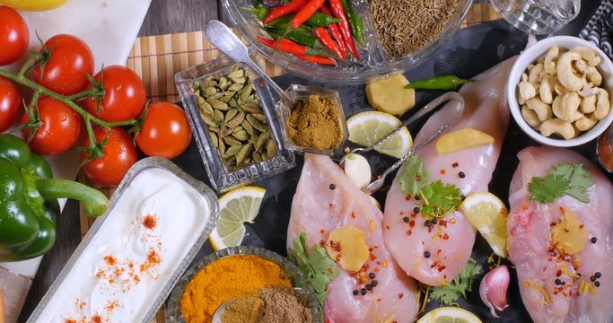 Dolly top down view of ingredients and indian spices for chicken tikka masala