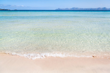 Cristal clear azure water in Alcudia beach in Mallorca, Spain