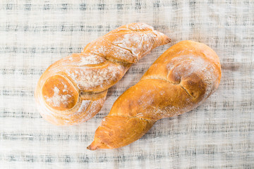 delicious baked goods on a light textile background, flat lay