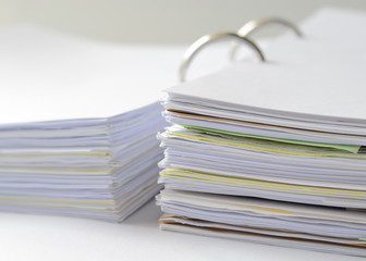 Stack of papers and business documents in document file on white table.office supplies. 
