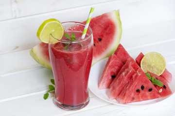 fresh  watermelon drink smoothie with mint and lime on white table.