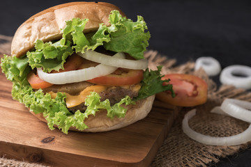 Homemade pork hamburger on black background
