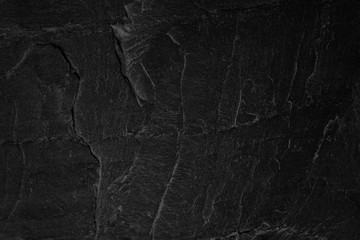 Dark grey black slate background or natural stone texture.