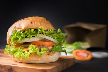 Homemade pork hamburger on black background