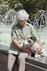 Senior woman on a walk with  her poodle dog 