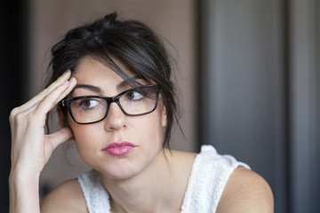 Portrait of beautiful young wondering woman with modern eyeglasses with black frame