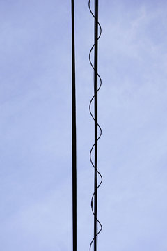 Directly below cables against blue sky