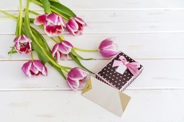 tulips flower on wooden background  with empty  card and gift box