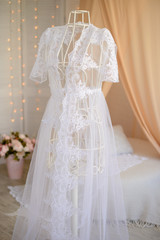 Fototapeta na wymiar White Wedding dress hanging from a dummy