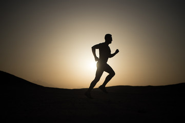 running man silhouette at sunset sky