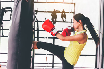 Woman punching bag with boxing gloves