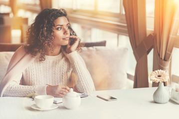 Attractive dreamy woman looking in the window