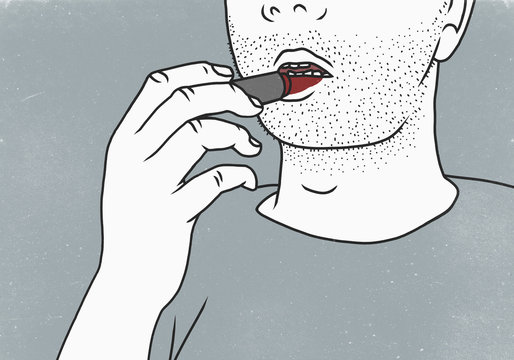 Midsection of man applying red lipstick against gray background