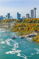 Canadian side of Niagara Falls with touristic boats