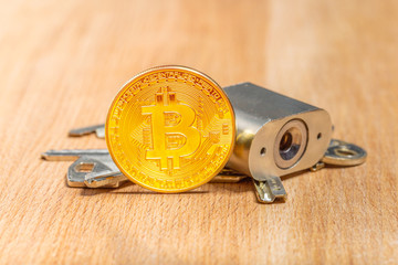 Gold bitcoin and padlock