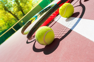 Tennis balls and racket on the grass court