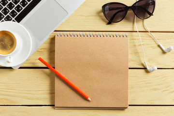 Office table background with coffee cup, pencils and computer keyboard. Business workplace or workspace concept.
