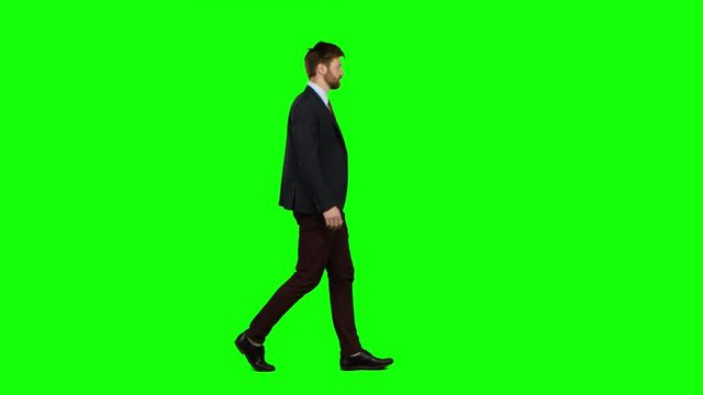 Businessman is going to a meeting and waving greetings. Green screen