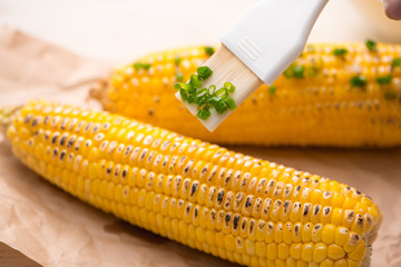 Tasty sweet grilled corn with onion sauce