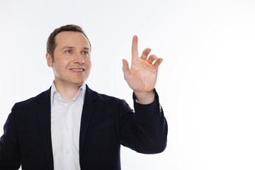 Cheerful interested man clicking on something