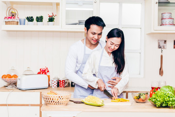 Young couple cooking food in the kitchen