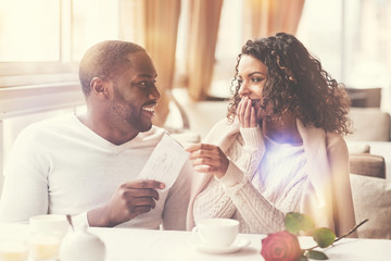 Cheerful nice woman sitting with her boyfriend