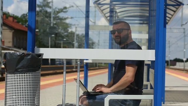 Man finish using laptop on the platform 
