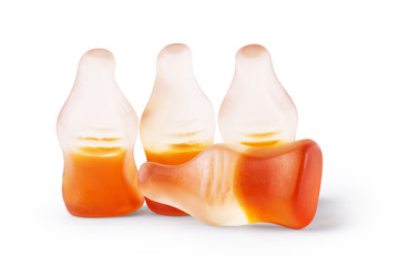 Cola flavored gummy jellies in the shape of cola bottles,isolated over white background.
