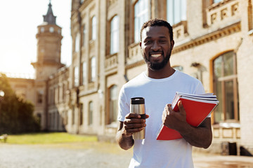 Motivated clever guy studying at the college