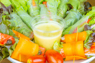 Close up of fresh salad of lettuce, cucumber and tomato on plate for healthy eating...Fresh vegetable salad in Black plate  on wood table. Salad for healthy. Fresh raw vegetables salad background.