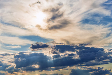 rays of the sun make their way through dramatic clouds