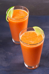 Carrot ginger smoothie, garnished with lime