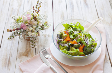 Warm vegetable salad with pumpkin, pearl barley and spinach on old wooden white background.