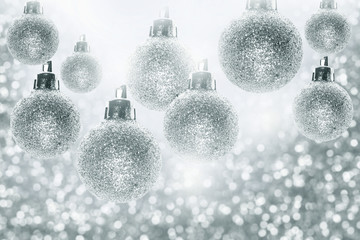 silver bokChristmas decorations, silver ball of christmas on bokeh background.eh texture. Festive glitter background with defocused lights