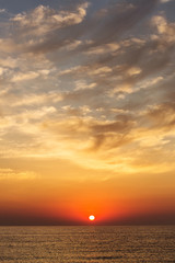 Sunrise over a sea with beautiful clouds above portrait photo very good for phone background