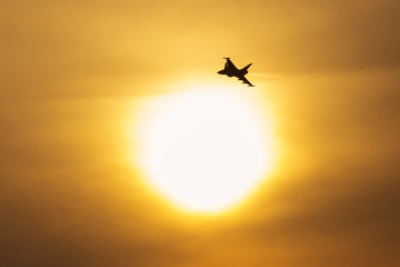 Supersonic jet fight airplane flying during sunset