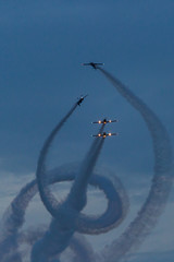 Silhouette of airplane on sunset with smoke in background