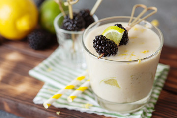 Lemon milkshake garnished with blackberry and mint