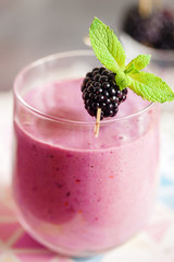 Delicious blackberry smoothie with mint and fresh berries in glass