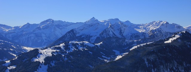 Winter morning in the Swiss Alps. View from mount Rellerli towards mount Oldenhorn and Glacier des Diablerets.