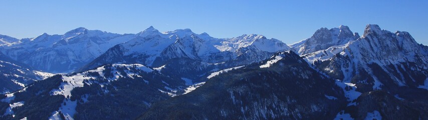 Fototapeta na wymiar Stunning view from mount Rellerli, Switzerland. High mountain Oldenhorn and other peaks. Winter landscape.
