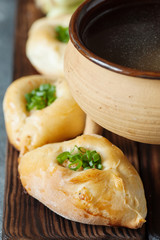 Russian patties rasstegai with fish and fish bouillon
