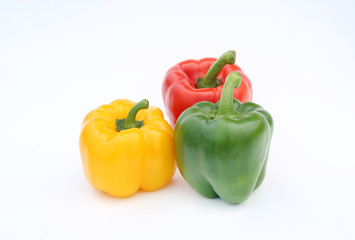 Green, red and yellow bell pepper isolated on white background.