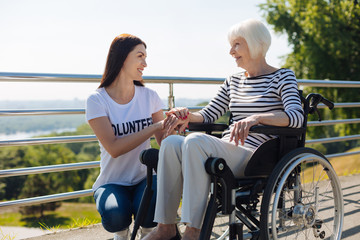 Brilliant genuine woman appreciating volunteers help