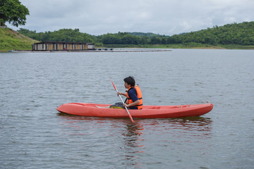 Man paddling in a kayak boat in Thailand