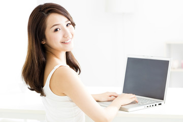 beautiful young smiling woman with  laptop .