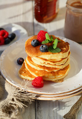 Stack of pancake with berry and syrup
