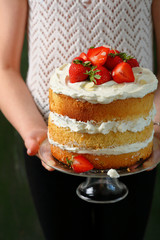 Summer cake in woman's hands