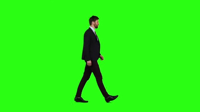 Man walks calmly down the street, he is happy. Green screen. Slow motion